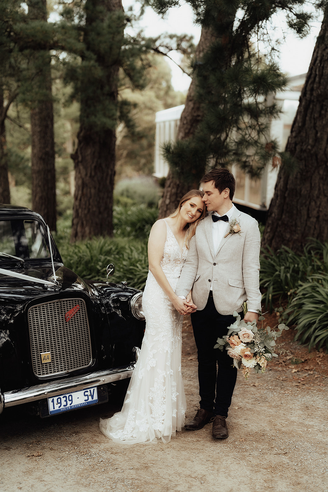 bride and groom with vintage car